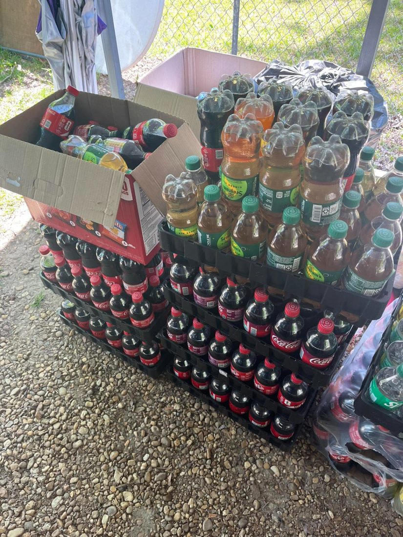 Cases of donated drinks ready to share at outreach