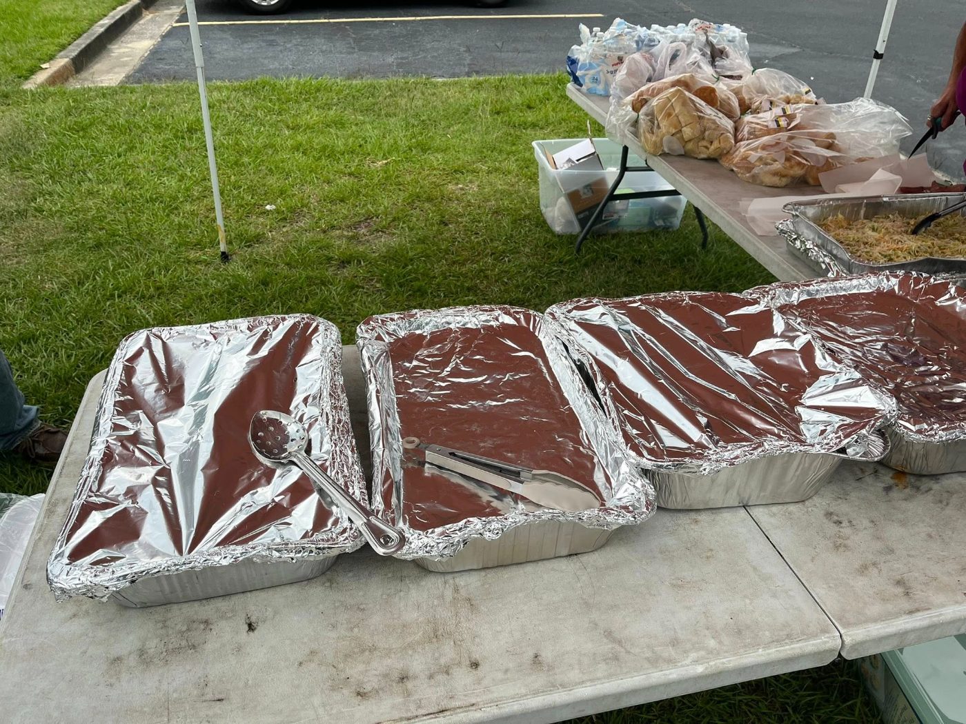Foil trays of hot food laid out on serving tables