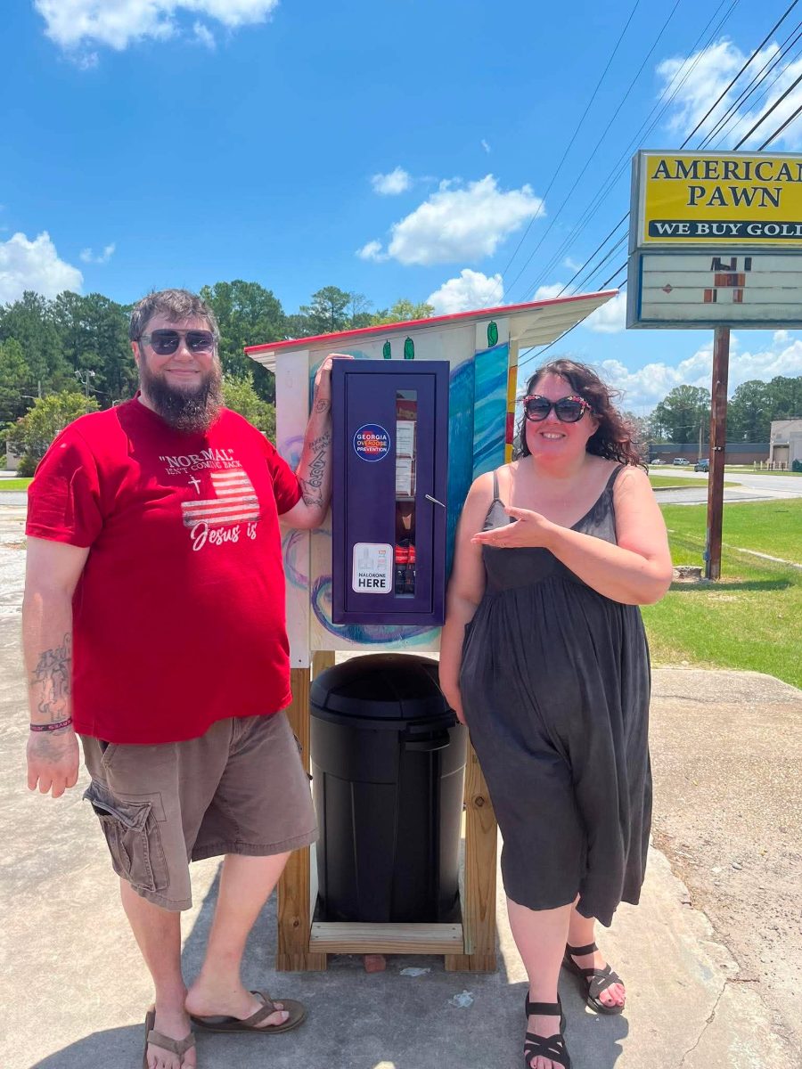 Founders standing by Lily's Blessing Box with its free Narcan overdose-prevention cabinet in Moultrie