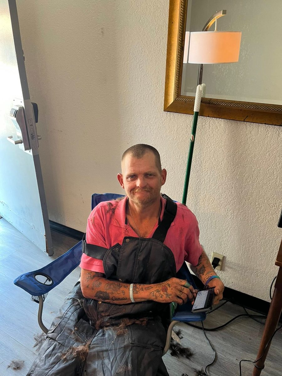 A man receiving a fresh haircut on Tuesday Shower Day