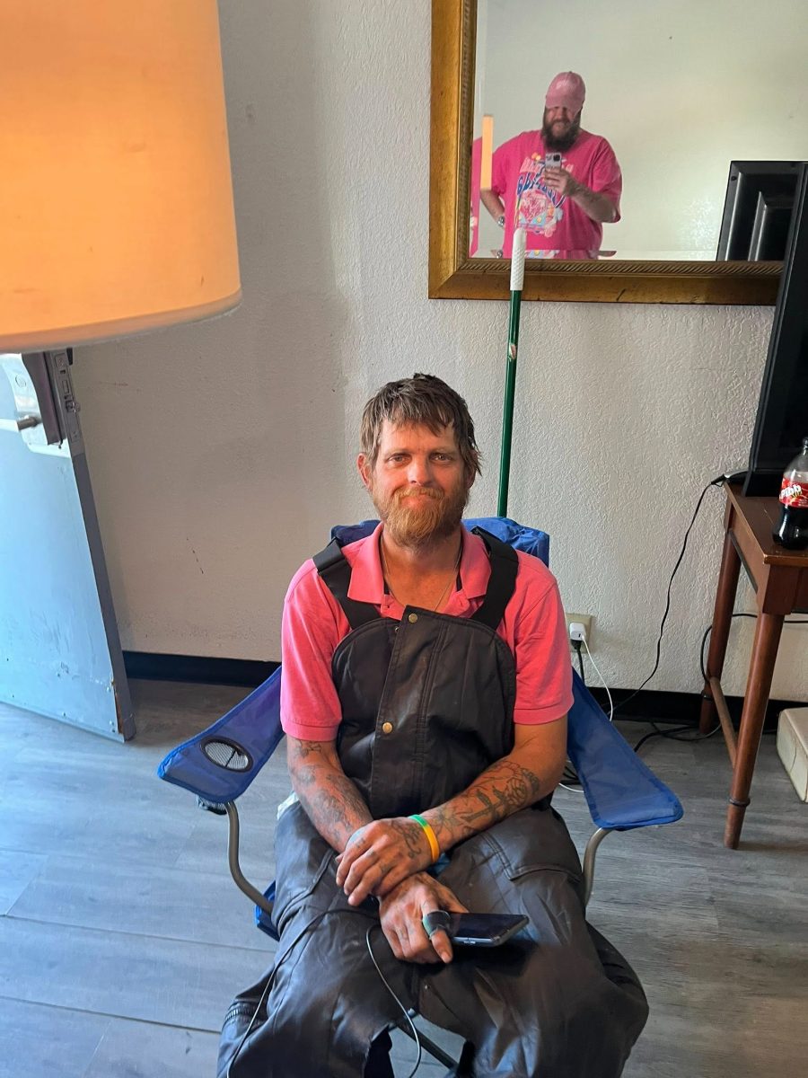 A guest smiling after a haircut and clean clothes on Shower Day
